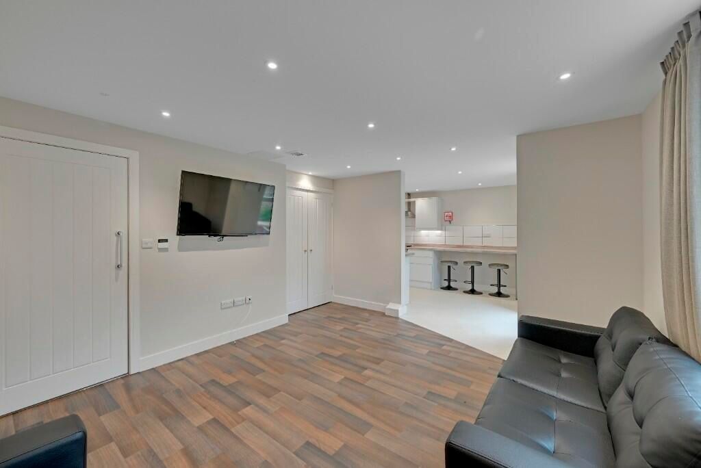 Property photo 2 of 15 A Modern Living Room Featuring Sleek Wooden Floori...
