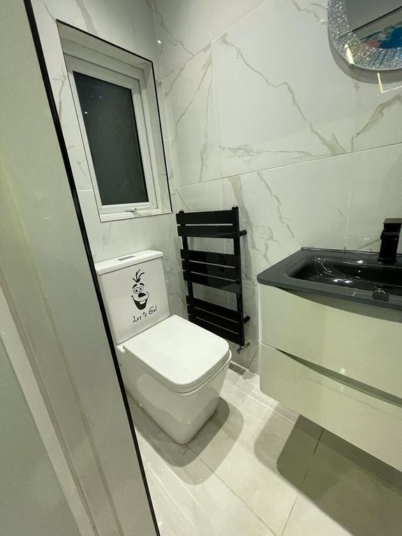 Property photo 1 of 12 Modern And Clean Single Toilet Room Featuring A Sl...