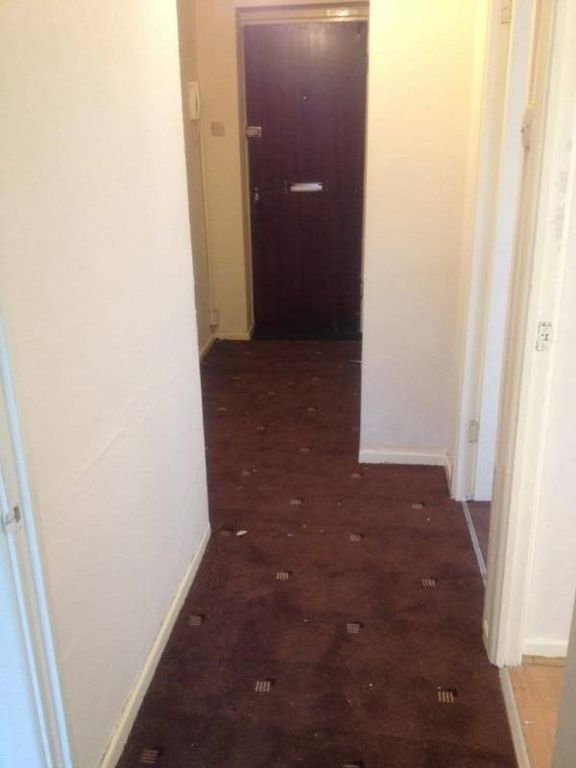 Property photo 2 of 2 Narrow Interior Hallway With Patterned Carpet Lead...