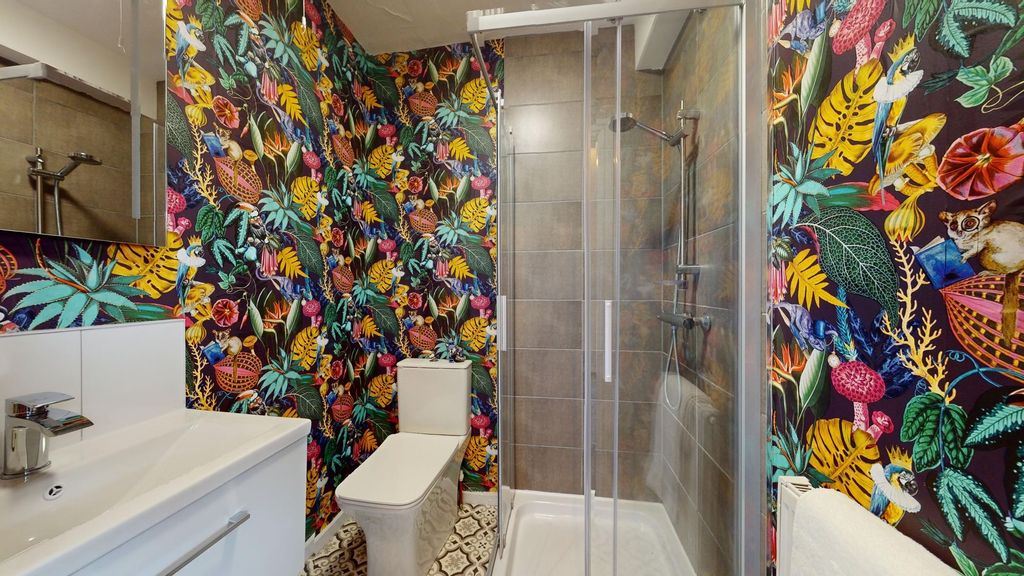 Property photo 3 of 12 This Vibrant And Modern Bathroom Features A Stylis...