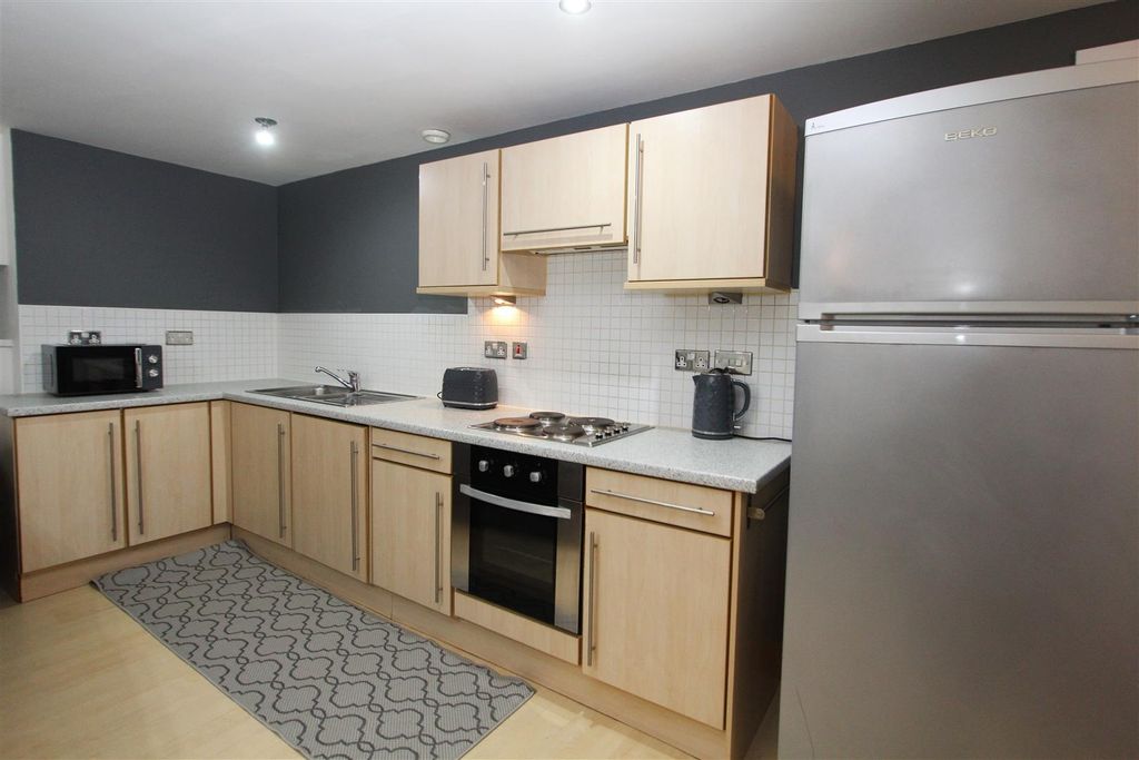 Property photo 2 of 8 Sleek Modern Kitchen With Ample Storage Space...