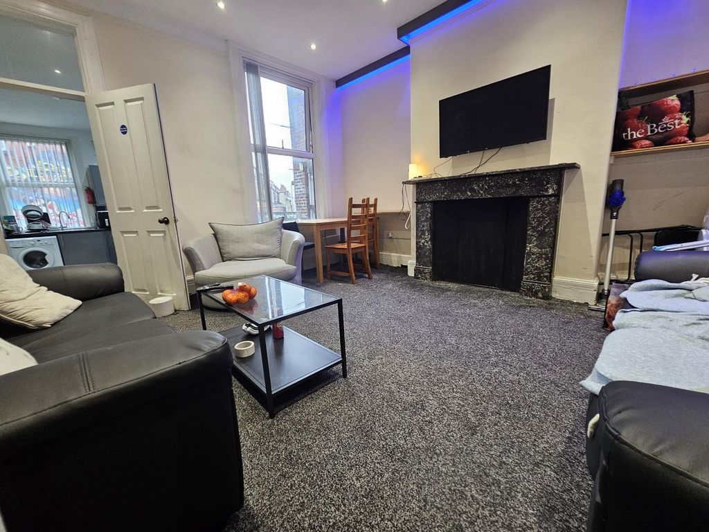 Property photo 2 of 22 A Spacious And Modern Living Room Featuring Comfor...