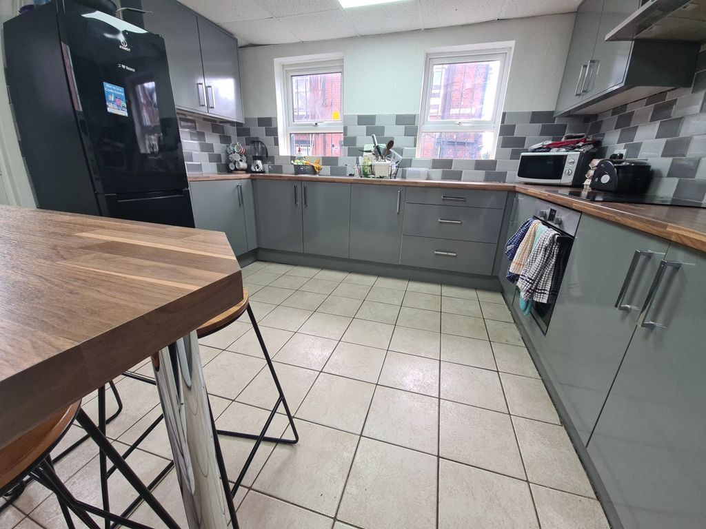 Property photo 3 of 26 A Modern Kitchen Featuring Sleek Cabinetry With Am...