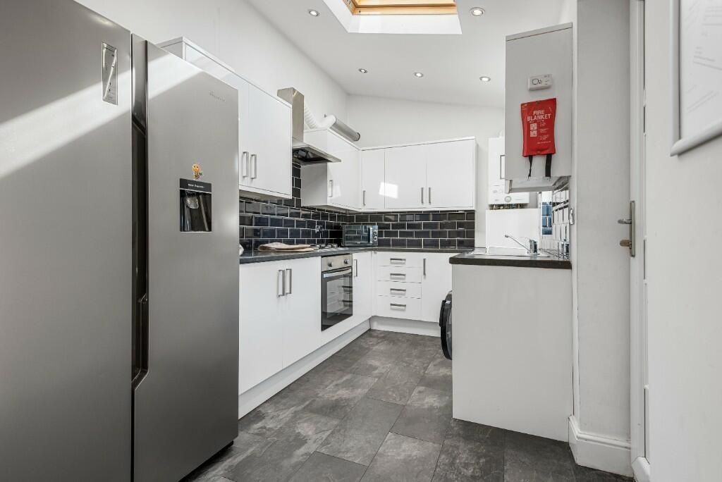 Property photo 3 of 14 Bright And Modern Kitchen With Sleek White Cabinet...