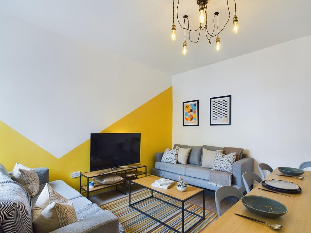 Property photo 3 of 15 A Stylish And Inviting Living Room Featuring Comfo...