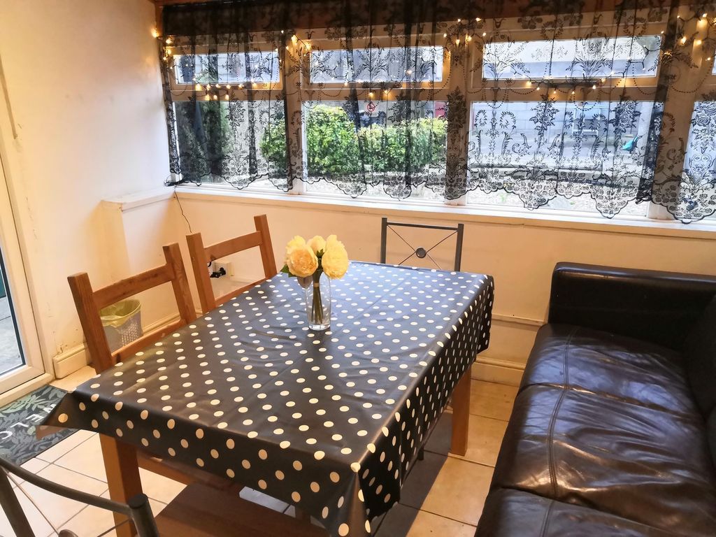 Property photo 1 of 10 Bright And Cozy Living Room Featuring A Large Wind...
