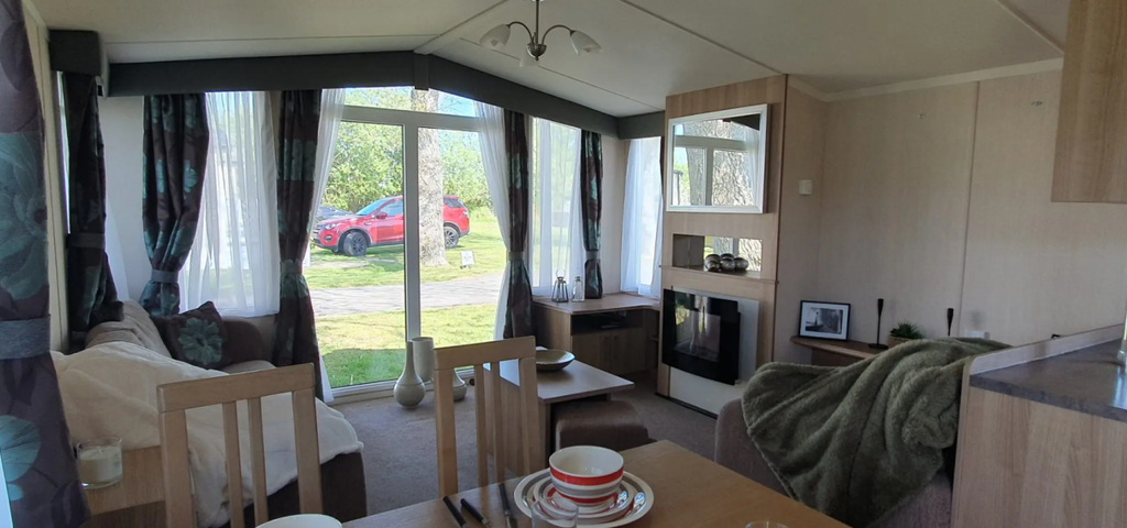 Property photo 3 of 6 Bright Lounge With Full Length Windows And Feature Fireplace