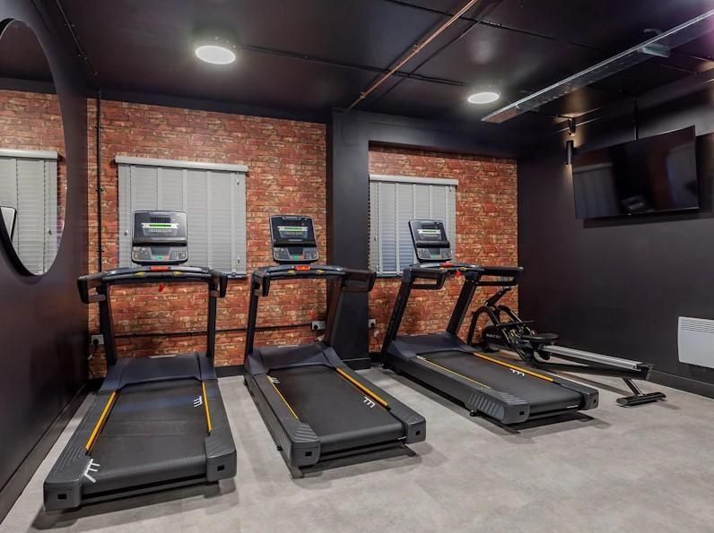 Property photo 1 of 8 A Well-Maintained Gym Area Equipped With Treadmill...