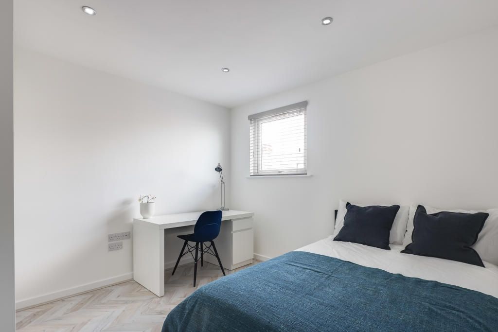 Property photo 2 of 12 A Bright And Modern Bedroom Featuring A Comfortabl...