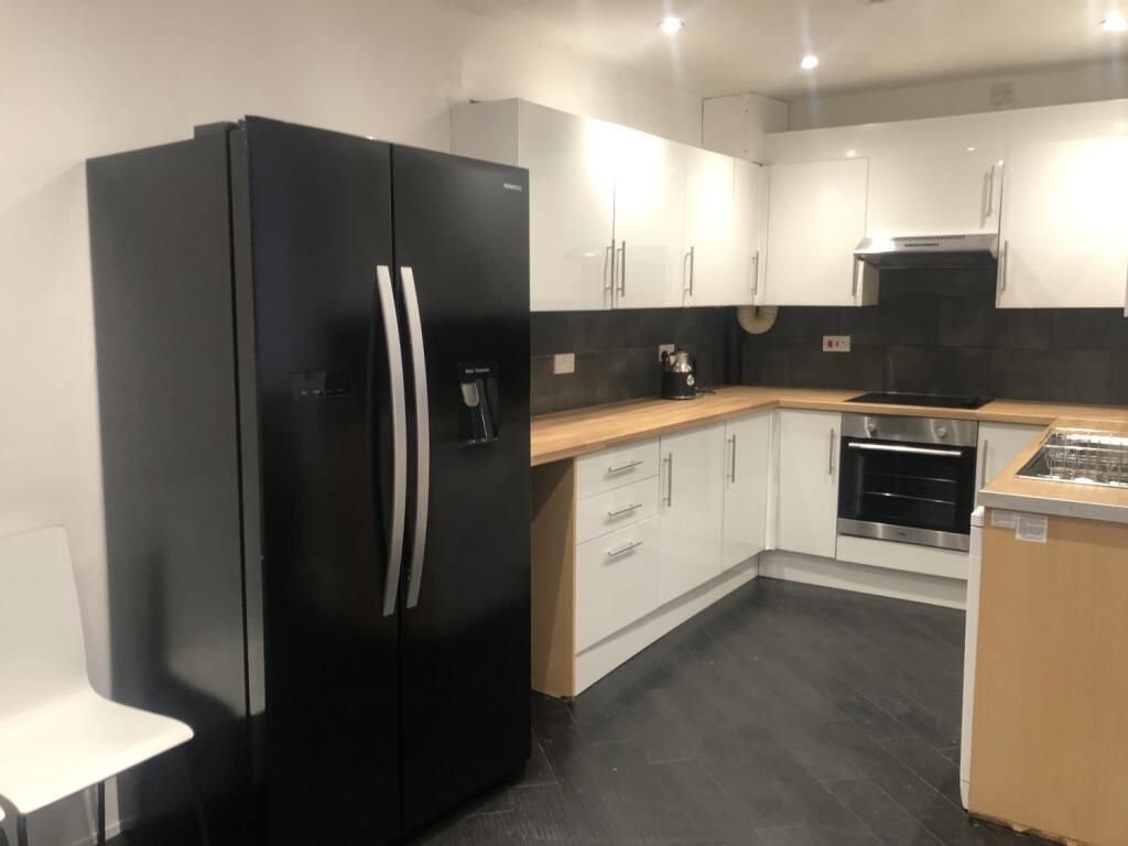 Property photo 1 of 11 Modern Kitchen Featuring Sleek Black And White Cab...