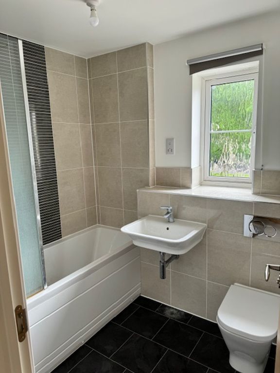 Property photo 2 of 6 A Modern And Clean Bathroom Featuring Both A Bath ...