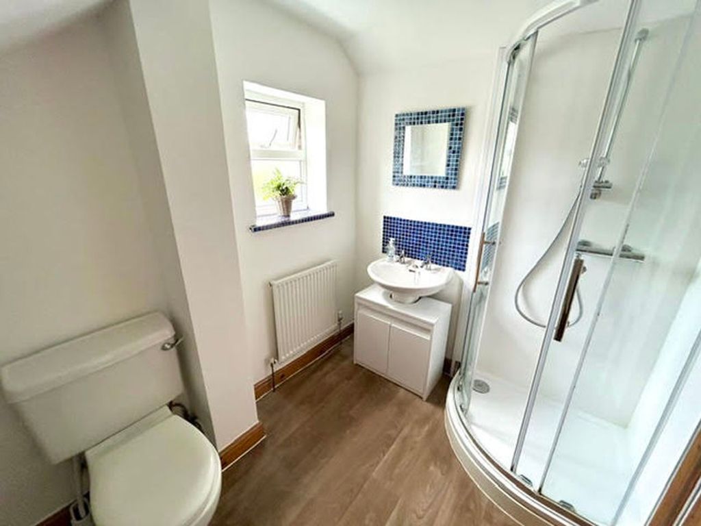 Property photo 2 of 8 A Bright And Modern Bathroom Featuring A Stylish S...