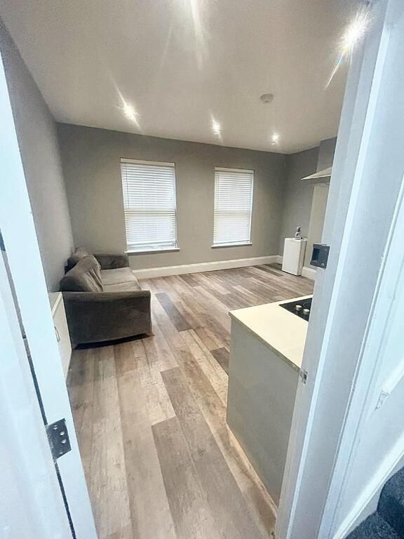 Property photo 1 of 9 A Modern, Well-Lit Living Room Featuring Two Large...