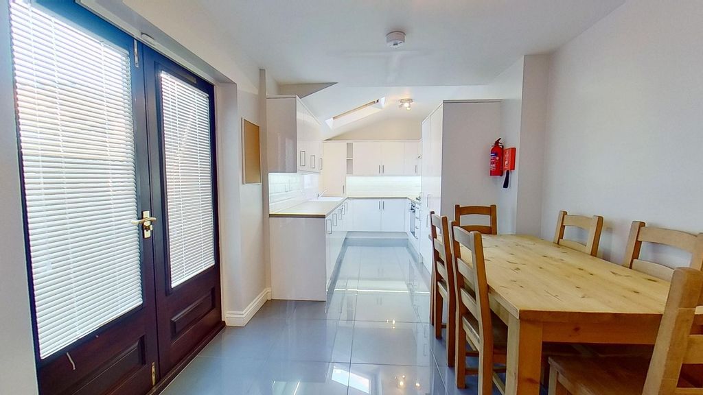 Property photo 1 of 11 Bright Modern Galley Kitchen And Dining Area With ...
