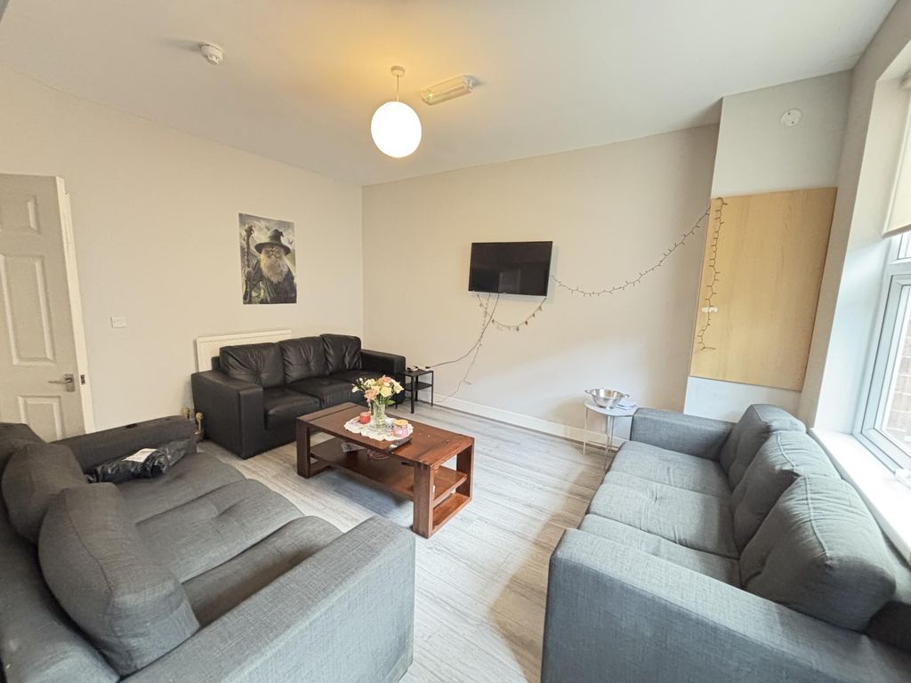 Property photo 2 of 16 Bright And Spacious Living Room Featuring Cozy Sof...