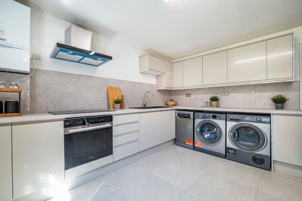 Property photo 3 of 10 Modern, Well-Lit Kitchen With Sleek White Cabinets...