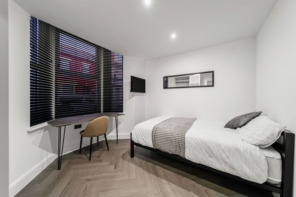 Property photo 3 of 4 A Bright And Modern Bedroom Featuring A Comfortabl...