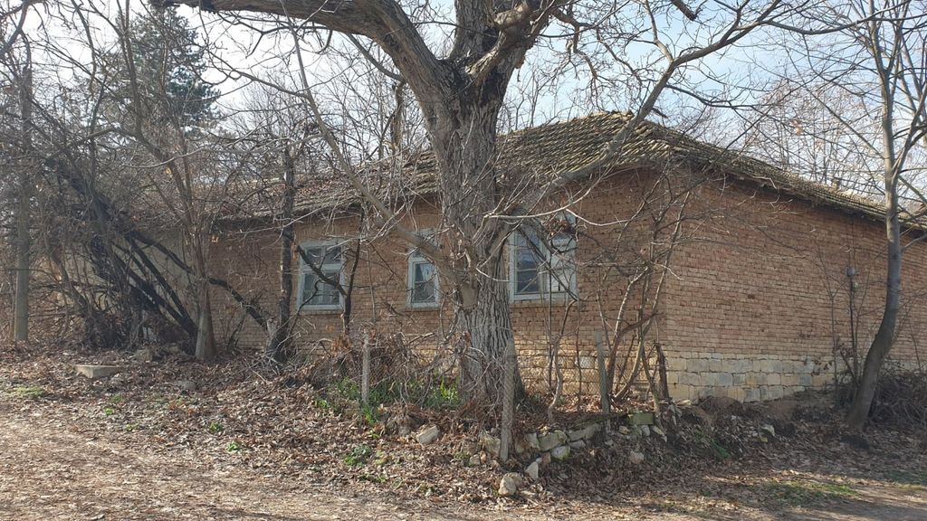Property photo 1 of 53 Exterior View Of A Brick House With A Stone Foundation And Leafless Trees In Front