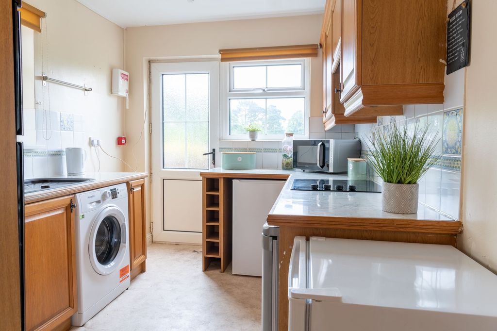 Property photo 1 of 9 Bright, Neatly Arranged Kitchen With Wooden Cabine...