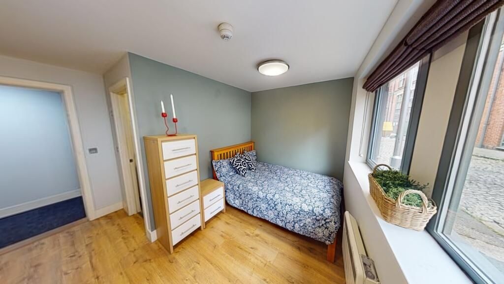 Property photo 3 of 9 A Cozy Single Bedroom Featuring A Wooden Floor, A ...