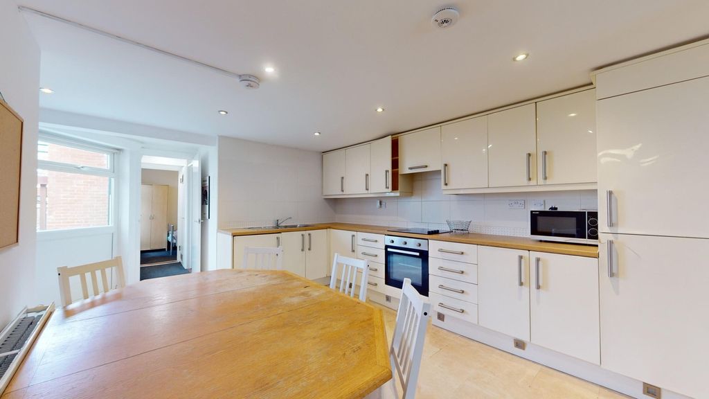 Property photo 3 of 15 A Spacious And Bright Kitchen Featuring Modern App...