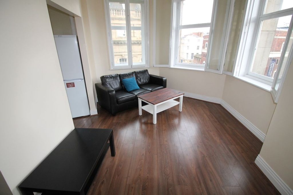 Property photo 1 of 8 Bright And Inviting Living Room Featuring Large Wi...