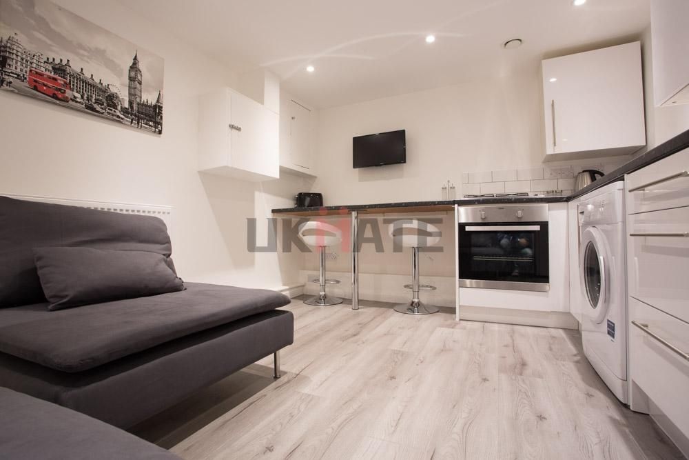 Property photo 1 of 15 A Modern And Tidy Living Area Featuring A Comforta...