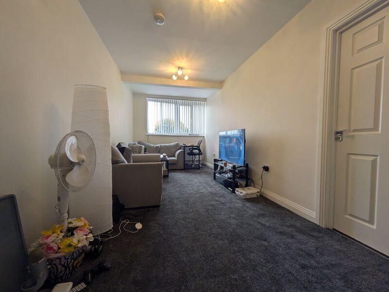 Property photo 1 of 9 Bright, Carpeted Living Room With A Large Window P...