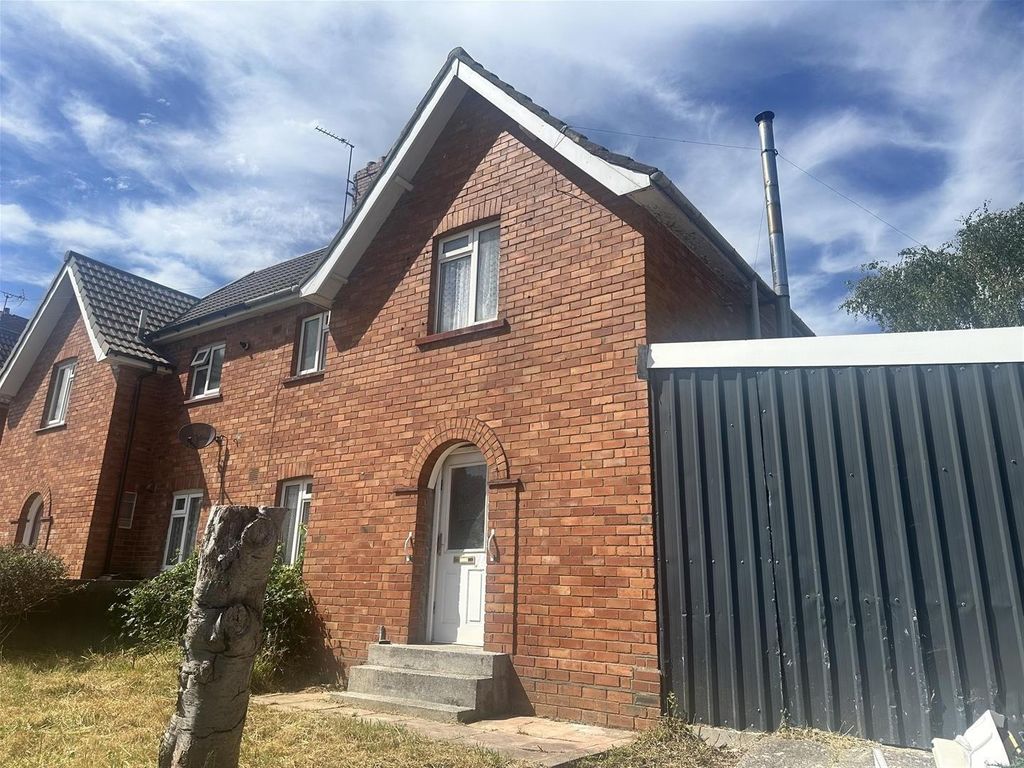 Property photo 1 of 16 Charming Red-Brick Home Under Bright Blue Skies...