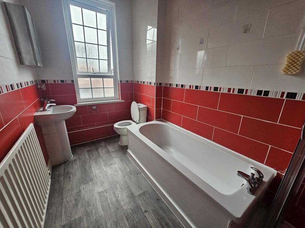 Property photo 1 of 12 Bright, Modern Bathroom With A White Bathtub, Pede...