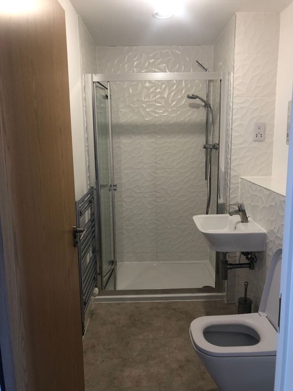 Property photo 3 of 12 Modern Bathroom With A Walk-In Shower And Textured...