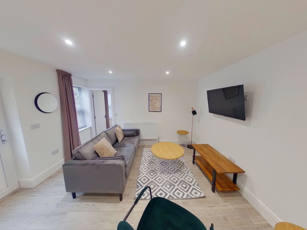 Property photo 1 of 9 A Spacious And Modern Living Room Featuring Stylis...