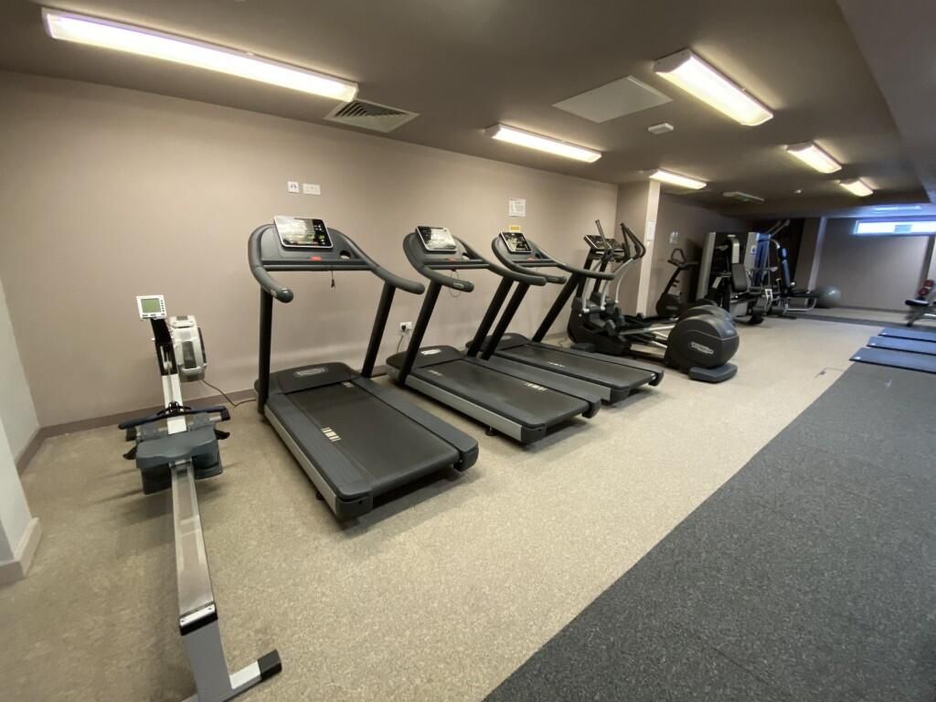 Property photo 2 of 7 Modern Gym Space Featuring Multiple Treadmills And...