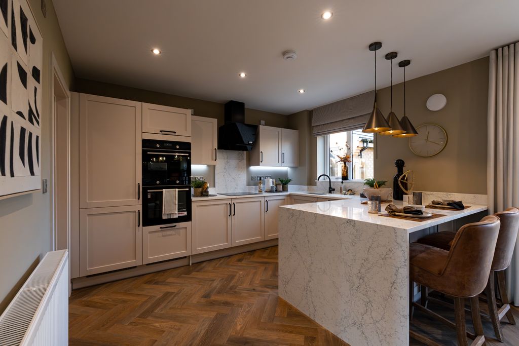 Property photo 2 of 10 A Modern Kitchen With A Marble Island And Bar Stools In The Foreground