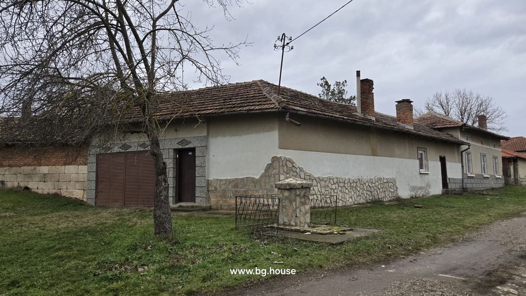 Property photo 3 of 90 Corner View Of A Bulgarian House Featuring Stone And Plaster Exterior Walls, A Metal Gate, And A Leafless Tree In Front.