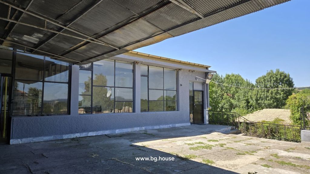 Property photo 2 of 52 Covered Terrace Area With Large Windows And Metal Door, Surrounded By Trees And Greenery