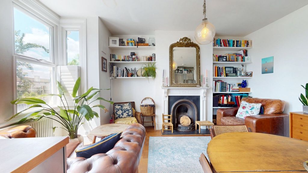 Property photo 2 of 14 A Bright And Inviting Living Room Featuring Large ...
