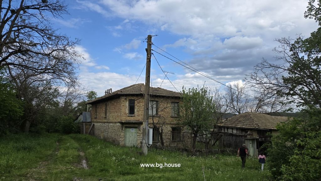 Property photo 1 of 100 View Of A Two-Storey Rural House With Stone Foundation And Brick Upper Walls, Surrounded By Trees And Green Grass.