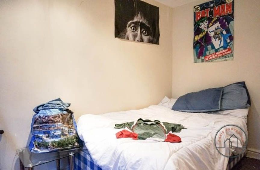 Property photo 2 of 4 Cozy Bedroom Featuring A Neatly Made Double Bed Wi...