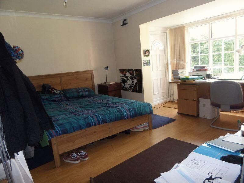 Property photo 3 of 9 A Well-Lit Bedroom Featuring A Spacious Layout Wit...