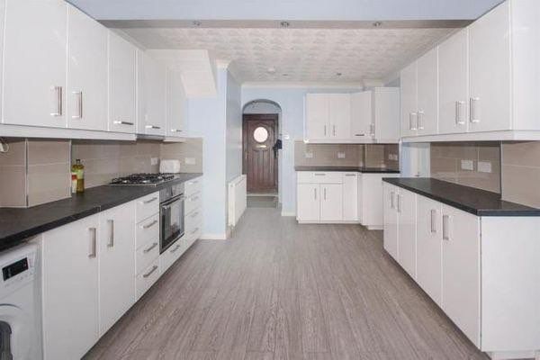 Property photo 2 of 11 Bright, Modern Galley Kitchen With White Cabinetry...