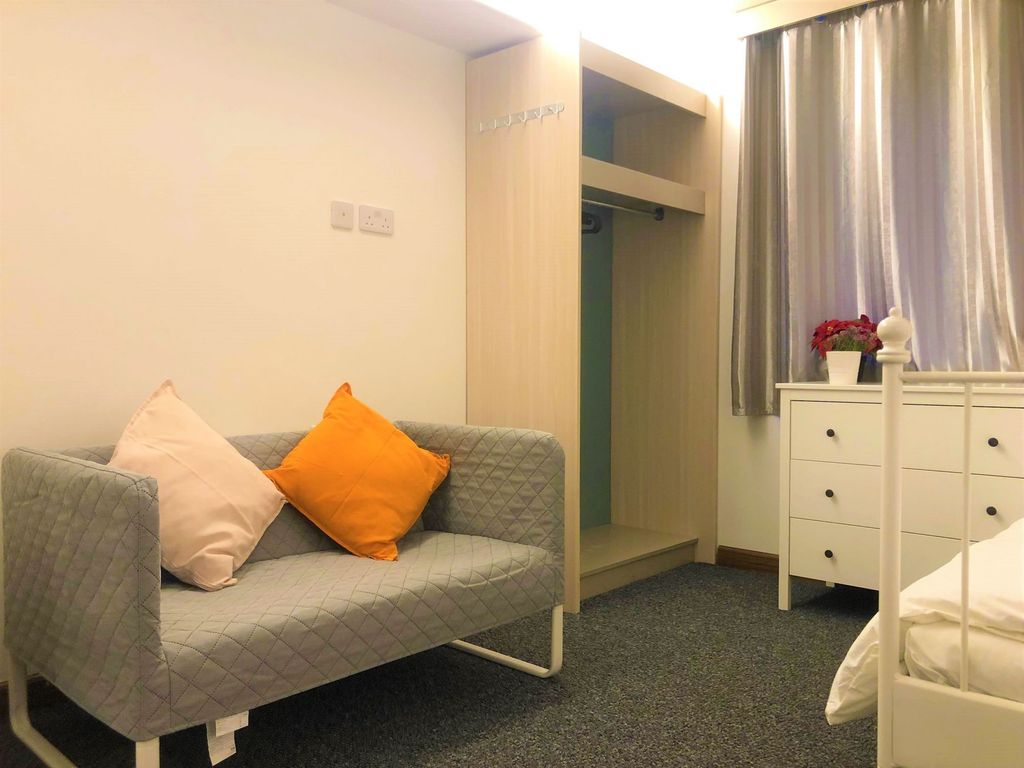 Property photo 2 of 9 A Cozy Single Bedroom Featuring A Neat Grey Sofa W...