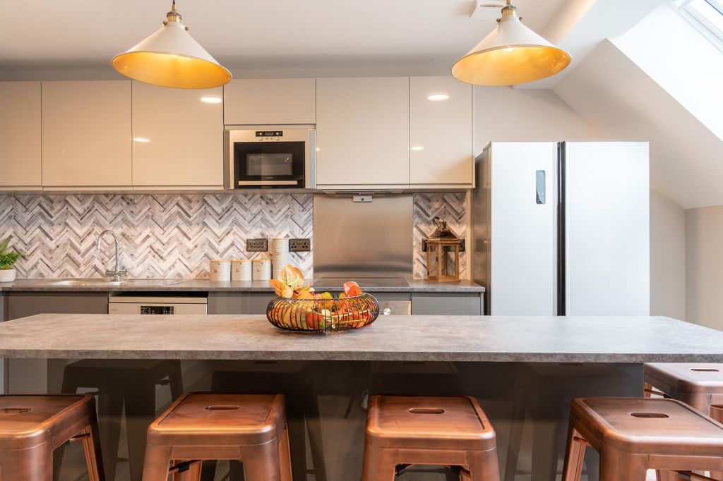 Property photo 2 of 13 Modern And Well-Maintained Kitchen Featuring Sleek...