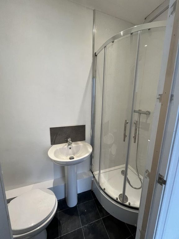 Property photo 3 of 5 A Well-Maintained Bathroom Featuring A Curved Glas...