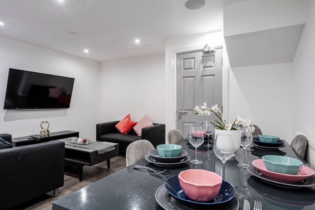 Property photo 1 of 11 Modern, Bright Living Room Featuring A Large Flat-...