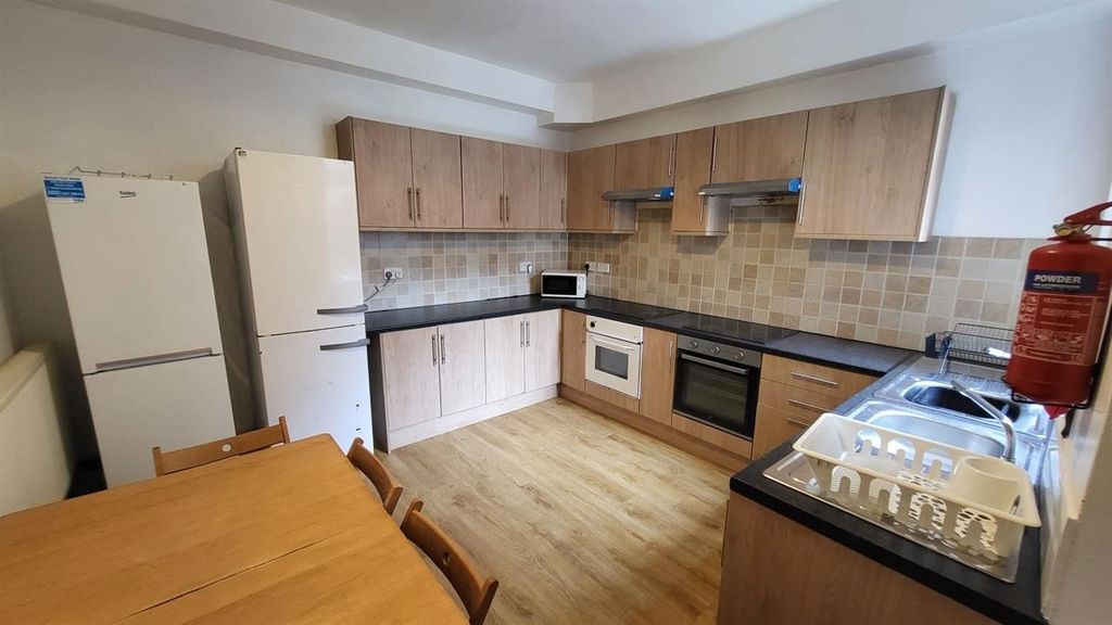 Property photo 2 of 14 Bright And Tidy Kitchen Featuring Modern Wooden Ca...