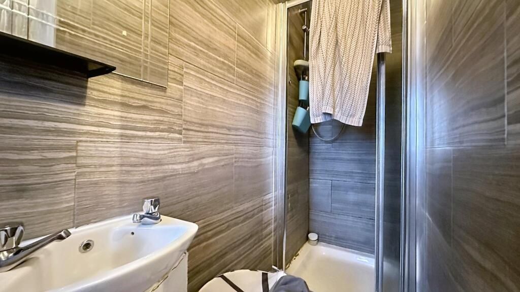 Property photo 2 of 5 Modern Tiled Bathroom With A Compact Walk-In Showe...