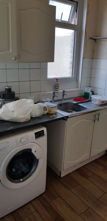 Property photo 3 of 4 Bright Kitchen Featuring A Washing Machine, Sink, ...