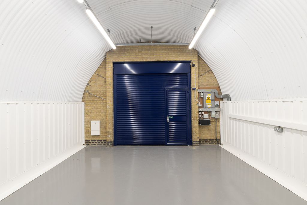 Property photo 2 of 4 An Empty Arch With White Lining, Facing The Front Electric Roller Shutter Entrance, Which Is Closed.