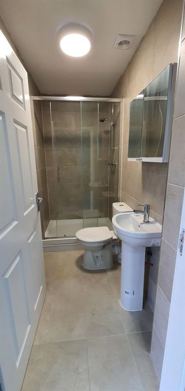 Property photo 3 of 8 Modern Tiled Bathroom With A Glass-Enclosed Shower...